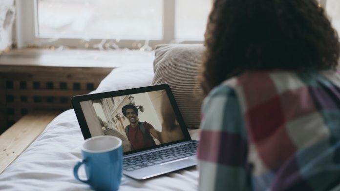 Photo by Vitaly Gariev Woman video chatting with a man on laptop.